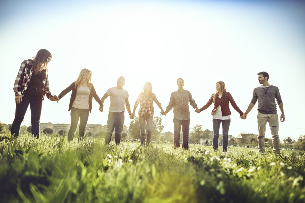 Friends together holding hands